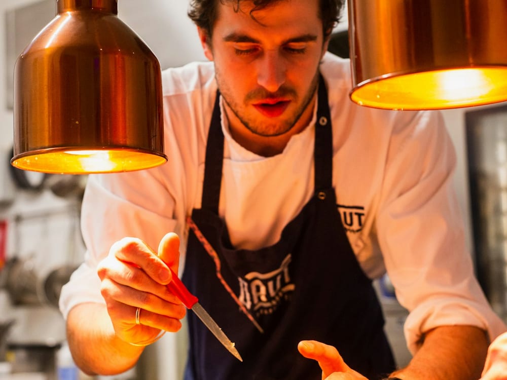 Chef plating food in a commercial kitchen